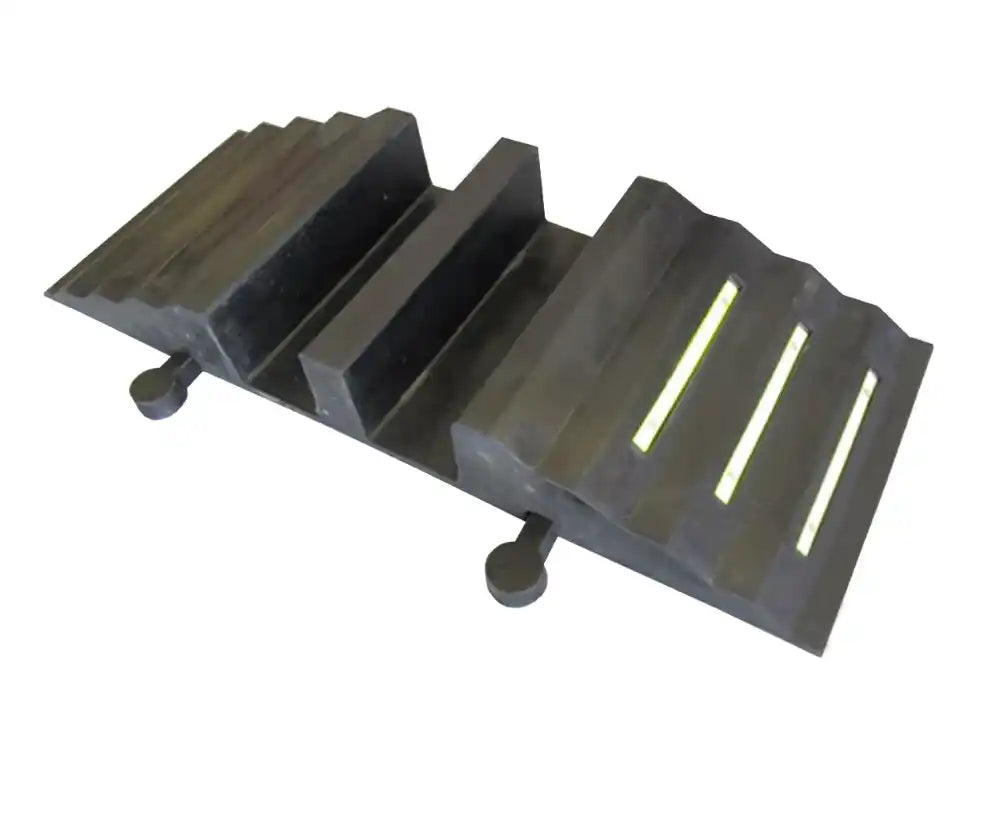 Angled view of the moulded rubber ramp, two open cable channels and yellow strips on the ribbed slope