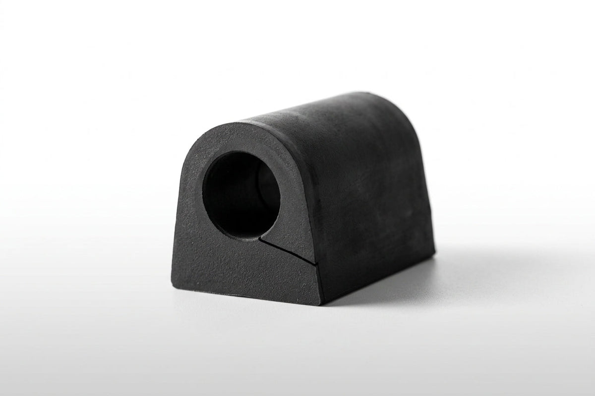 Black rubber D-shaped anti-roll bar bush, studio shot on white background