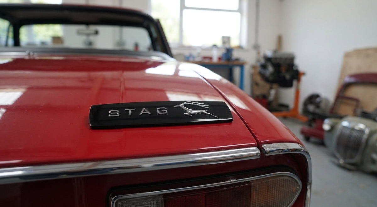 Black STAG side badge fitted to the rear wing of a red Triumph Stag Mk2