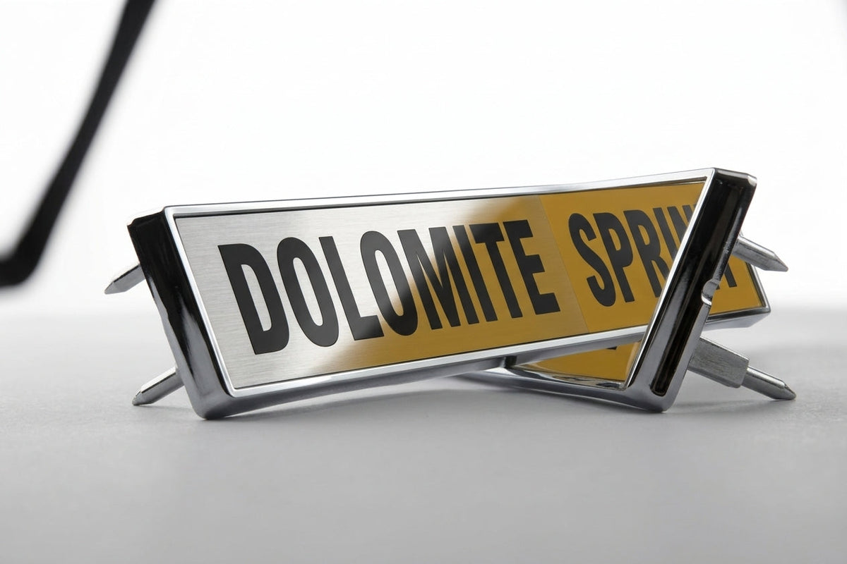 Gold and black DOLOMITE SPRINT boot badges on white background, studio shot