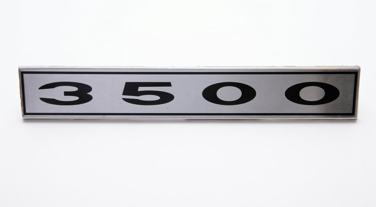 Silver metal badge reading 3500 on a plain white background