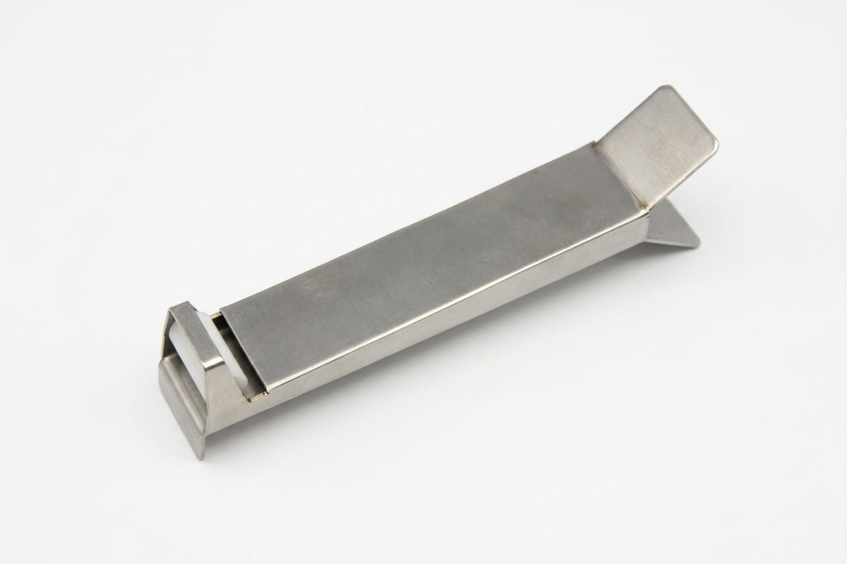 Stainless steel glazing fitting tool on a plain studio background