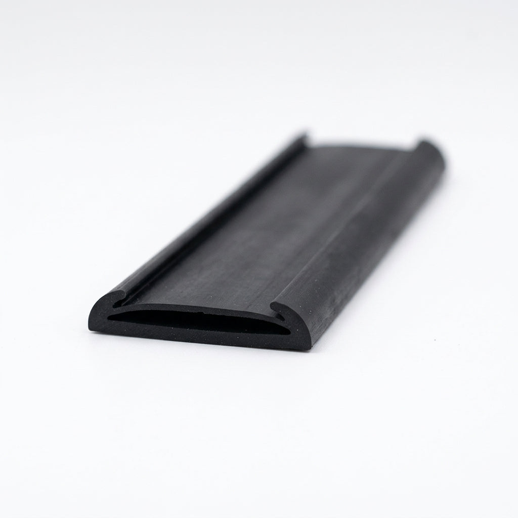 Black rubber flat strap with curled edges, angled studio shot