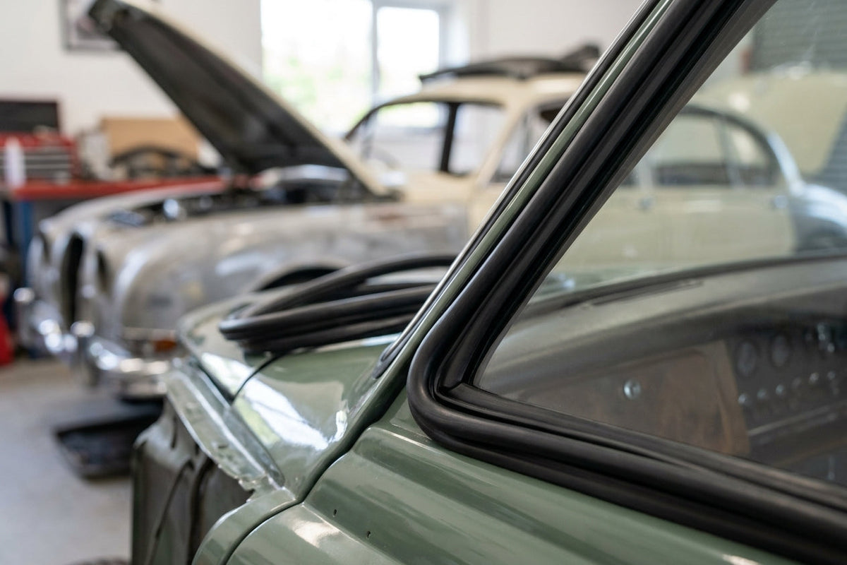 Windscreen seal fitted to the A-post of a green classic Jaguar saloon