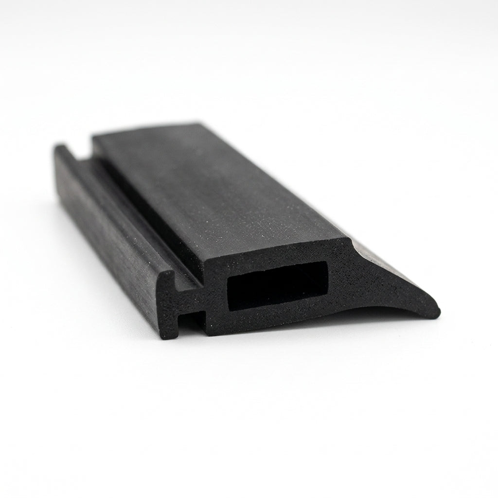 Black solid neoprene T-section with a hooked mounting foot and hollow slot, angled studio shot