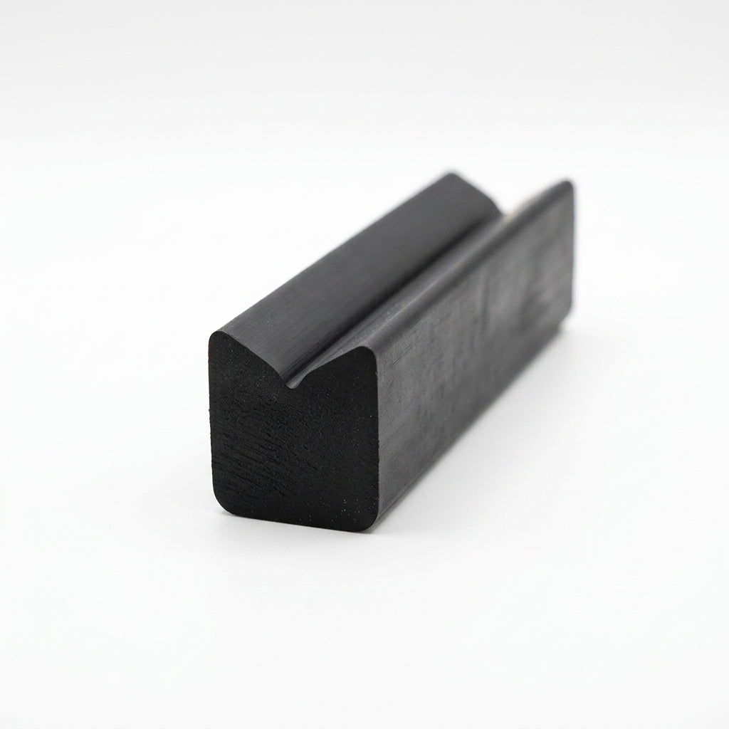 Black rubber block extrusion with twin-peak top, angled studio shot
