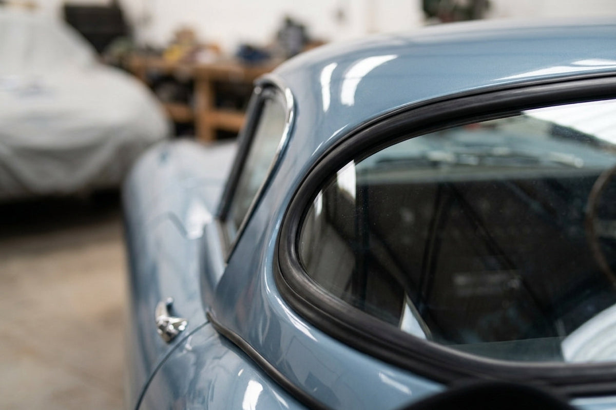 Windscreen seal fitted to the hardtop rear window corner of a light blue Jaguar E-Type