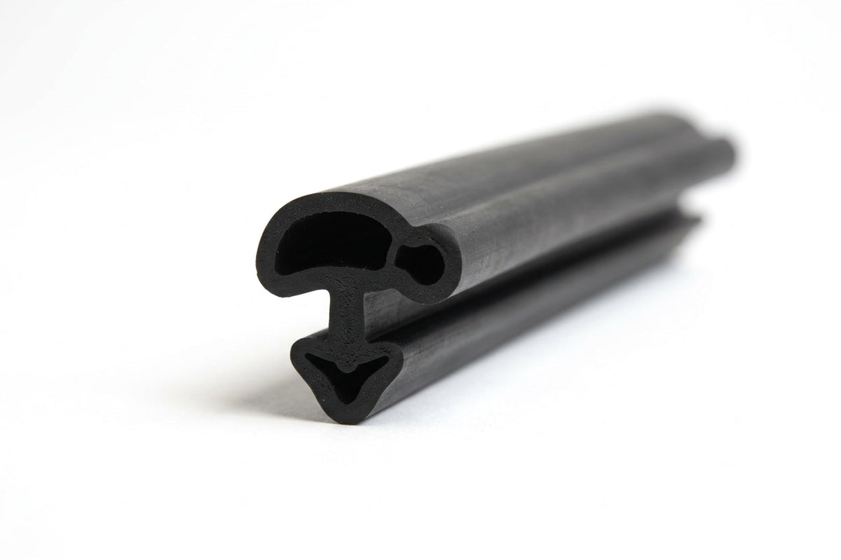 Black rubber seal with bulb and locking leg profile, coiled length on white background