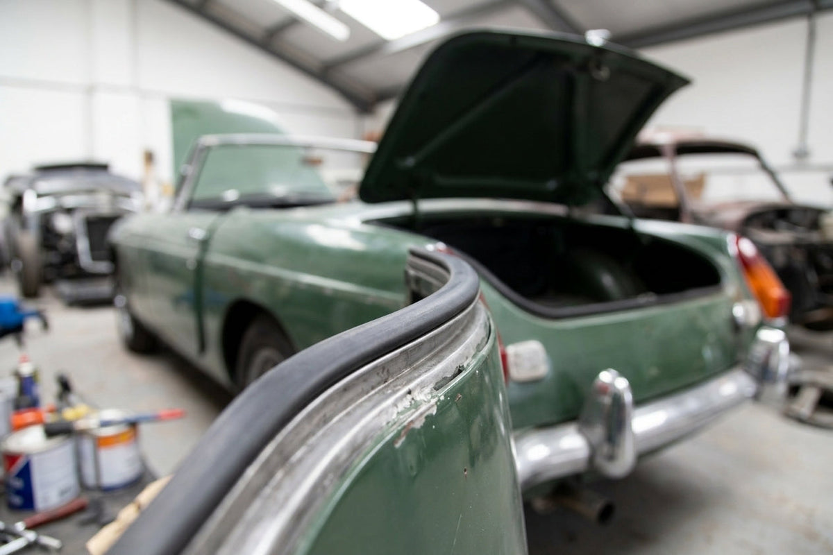 Sponge strip fitted along the boot edge of a green classic convertible
