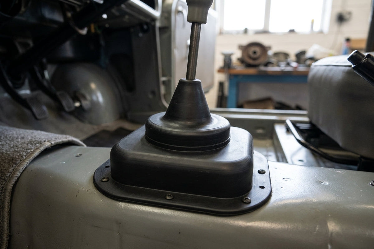 Black rubber gear lever gaiter fitted around the gearstick in a car interior