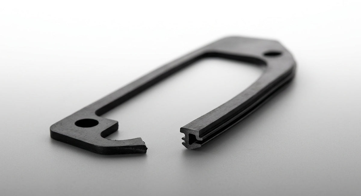 Black moulded rubber door handle gasket shown at an angle, studio shot