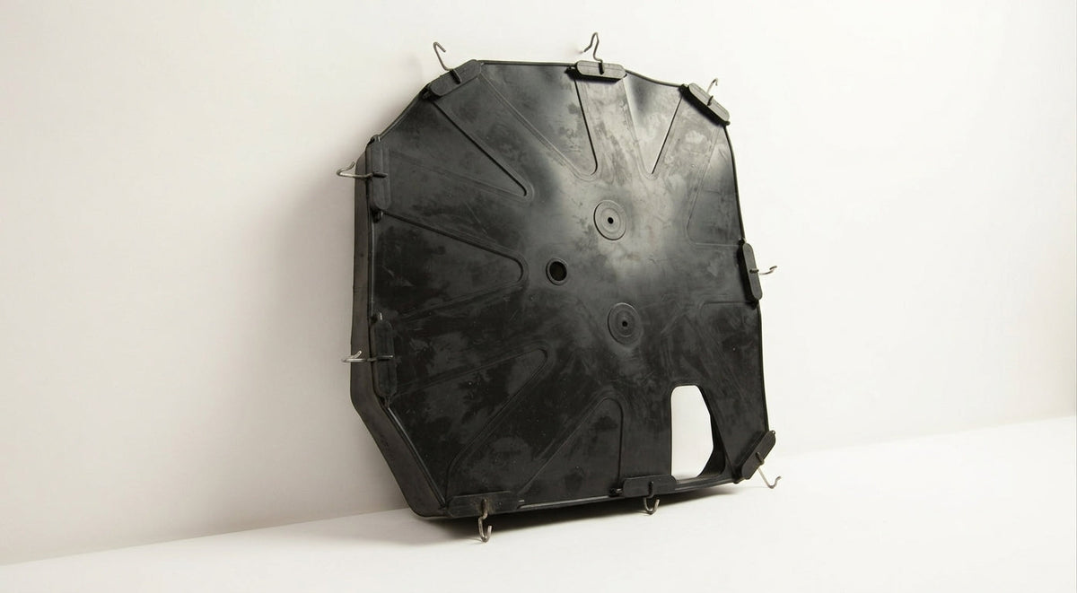 Black moulded seat diaphragm with a notched edge and metal hooks, studio shot