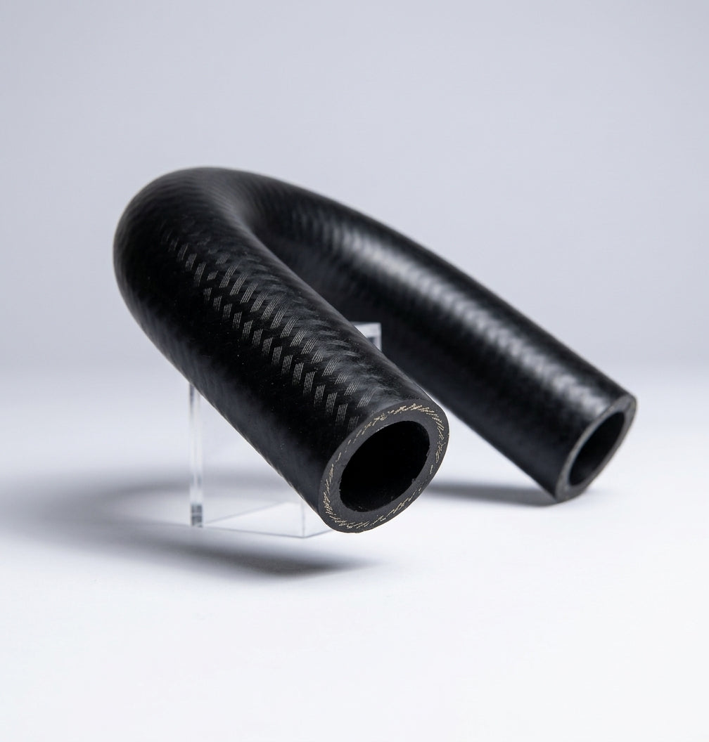 Black woven-finish bypass hose bent into shape, propped on a clear stand