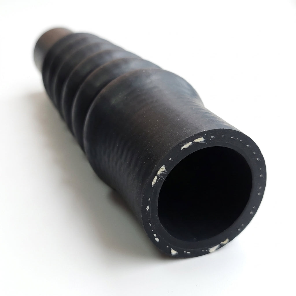 Black accordion-ribbed radiator hose shown end-on with open bore