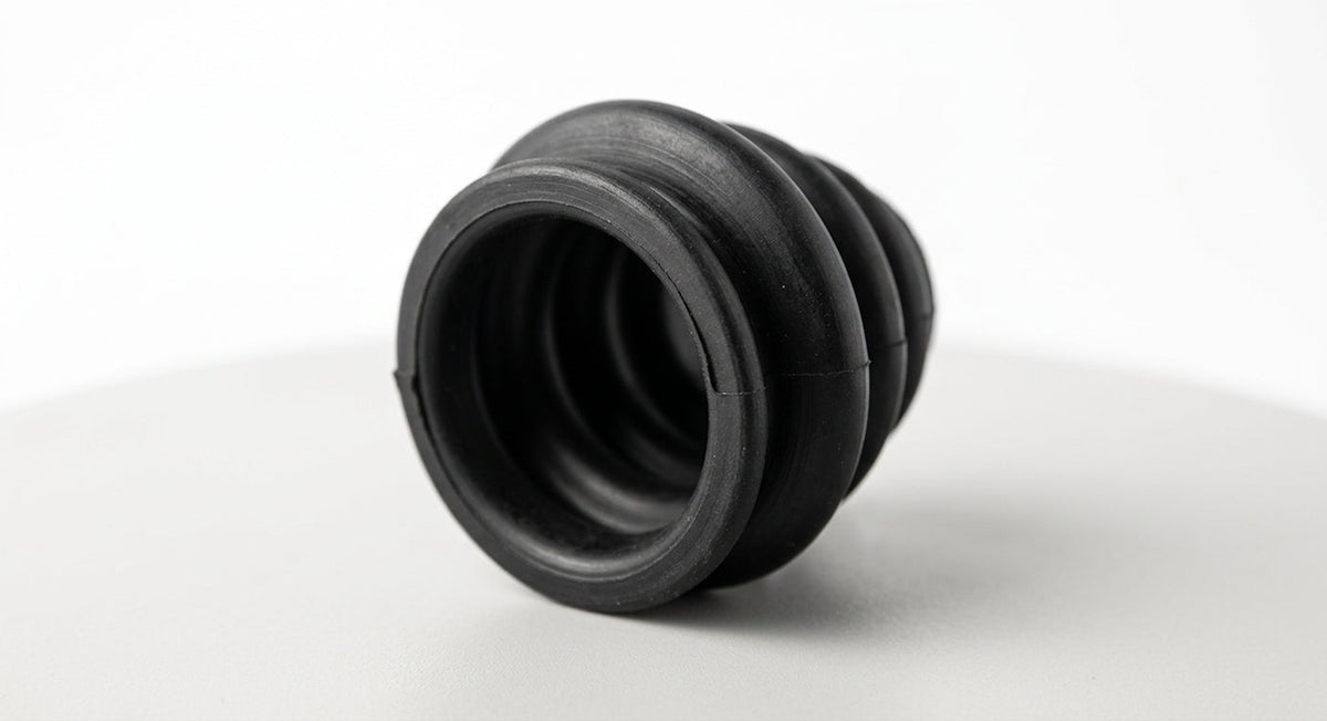 Black convoluted rubber steering column gaiter, angled studio shot on white background