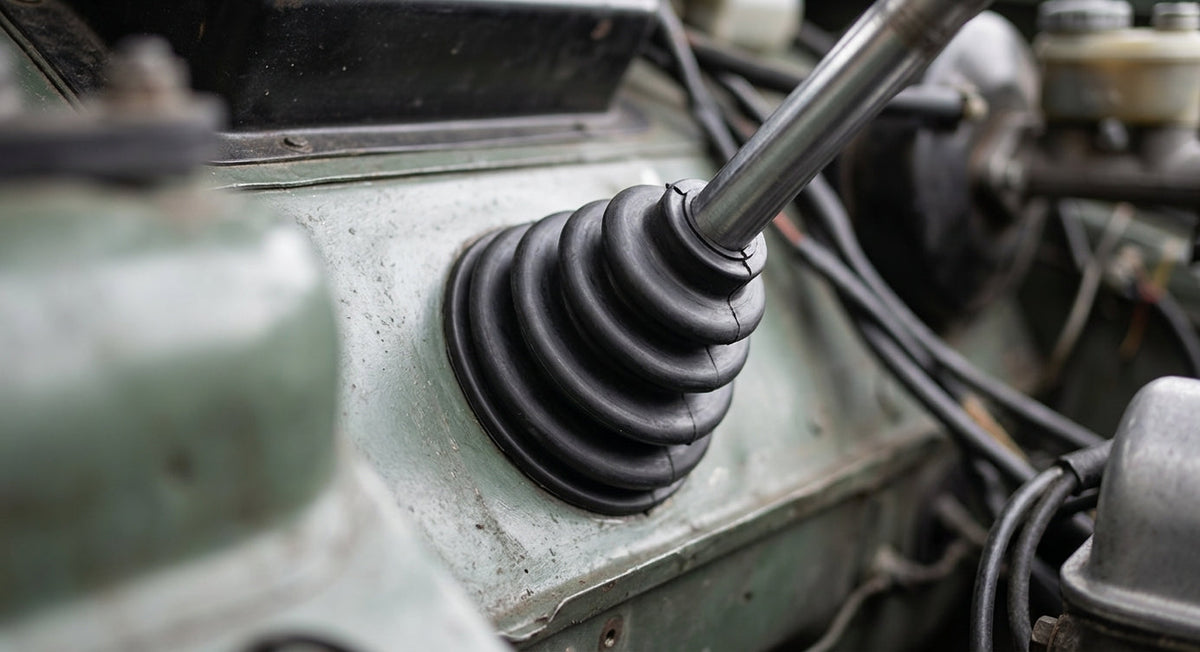 Steering column gaiter fitted in the engine bay of a green classic Jaguar