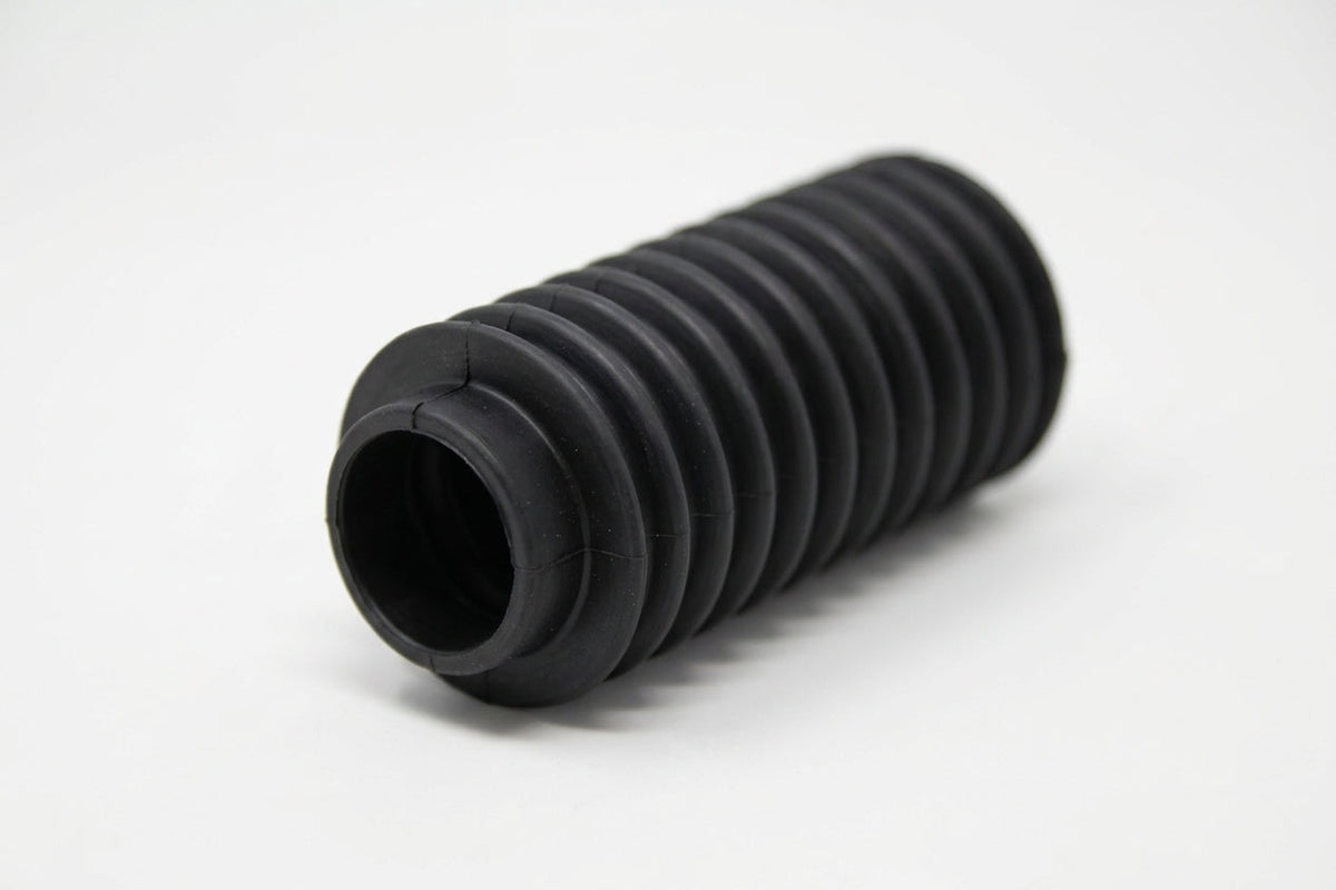 Black convoluted rubber steering rack gaiter, angled studio shot on white background