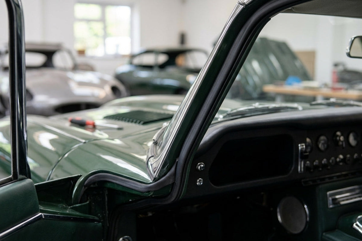 Door seal fitted along the frame of a green classic Jaguar E-Type