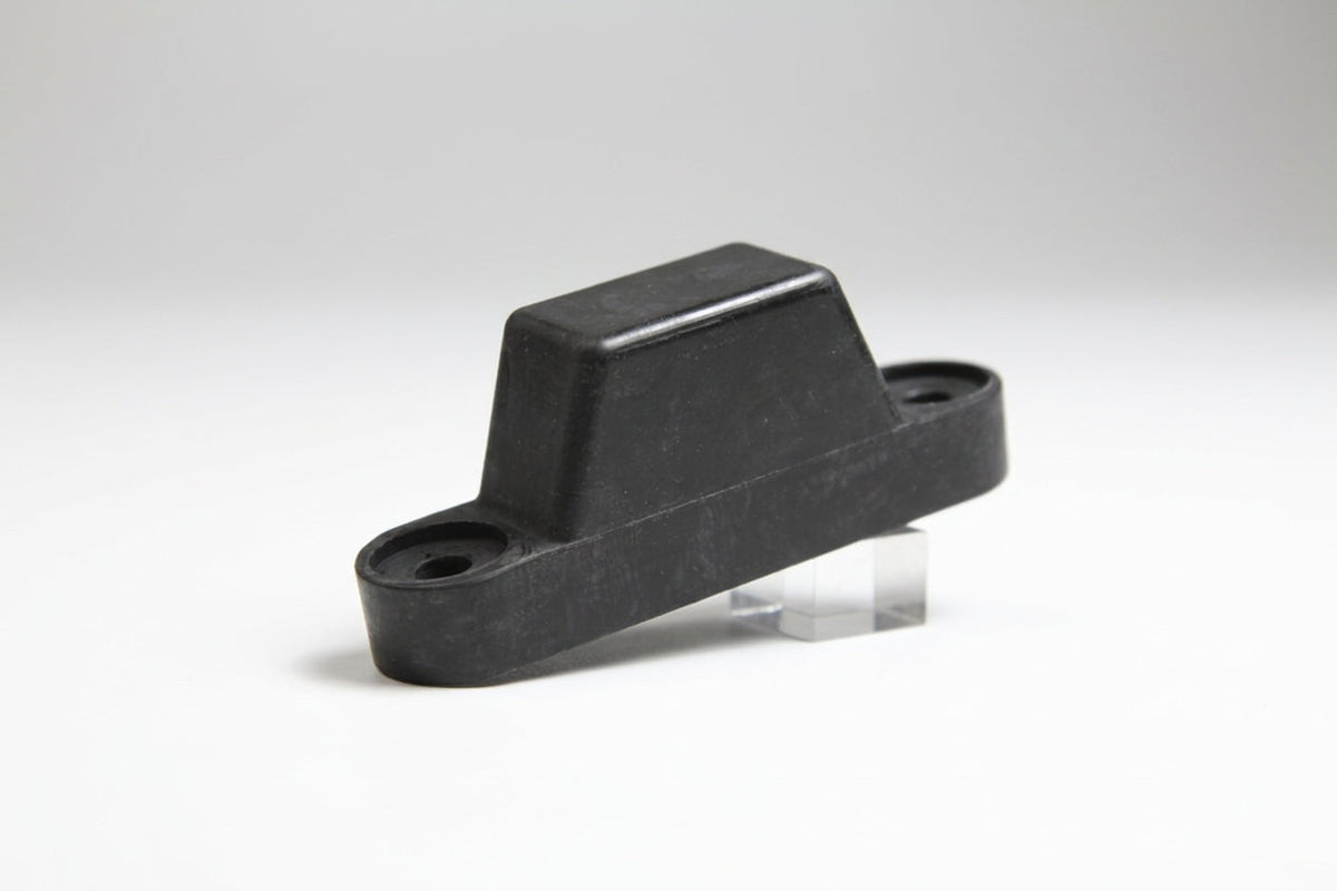 Moulded black rubber tailboard buffer block with two mounting holes