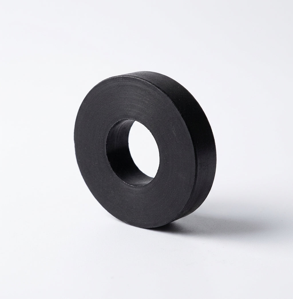 Black rubber mounting ring with a central hole, studio shot on white background