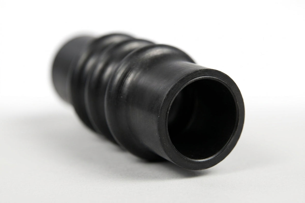 Black ribbed rubber radiator hose with a bellows section, studio shot