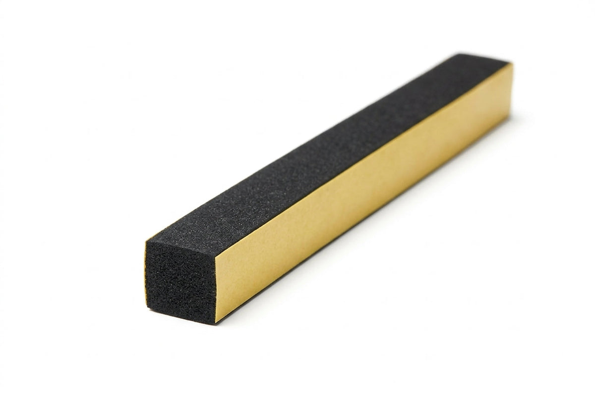 Black square sponge strip with yellow self-adhesive release paper along one edge, angled studio shot