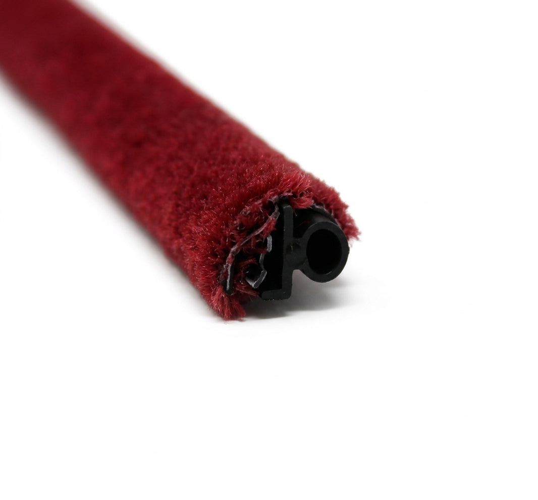 End-on view of red pile-covered trim showing its black rubber core