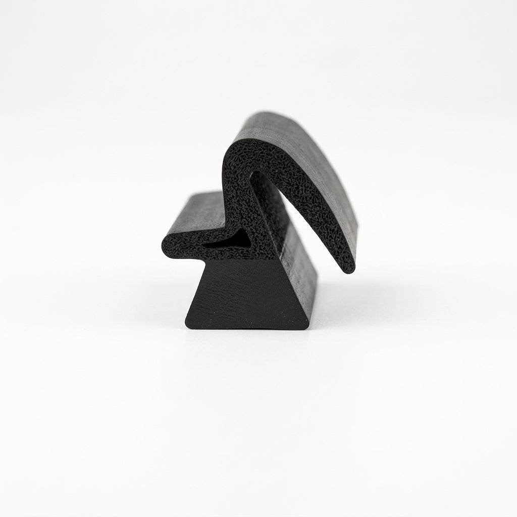Black dual-hardness sponge section seal, end-on studio shot showing the profile