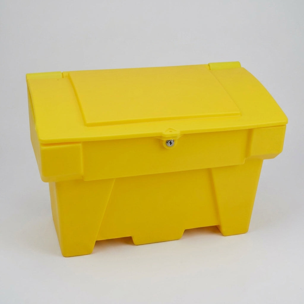 Yellow polyethylene grit bin photographed against a plain grey background, lid closed, three-quarter view