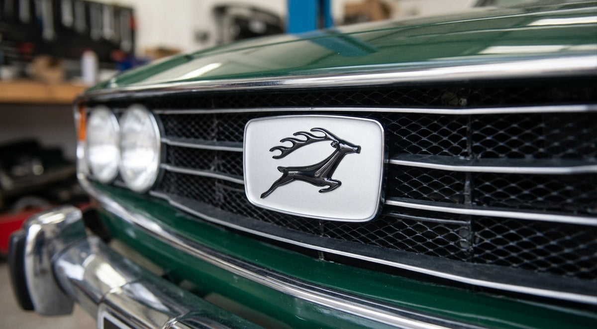 Silver leaping stag grille badge fitted to a green Triumph Stag Mk1 front grille