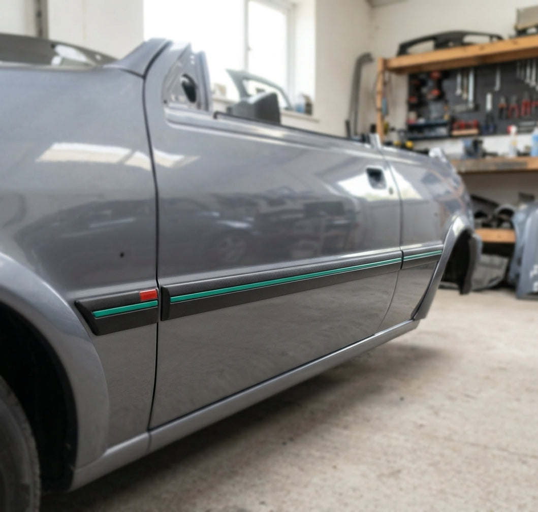 Black side mouldings with green insert fitted along a grey Fiesta RS Turbo's doors