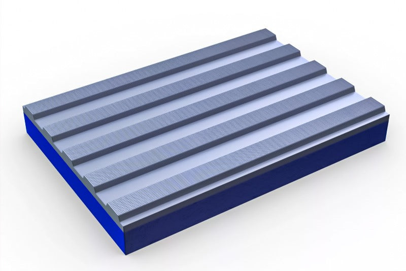 An angled product shot of a rectangular, two-tone heavy-duty anti-fatigue mat. The bottom layer of the mat is a solid blue, while the top surface is light grey with five prominent, raised, horizontal ribs. The ridges feature a fine, close-set ribbed pattern for an enhanced slip-resistant texture. This image highlights the extra-resilient PVC matting, an industrial comfort and safety flooring solution designed for both wet and dry areas.