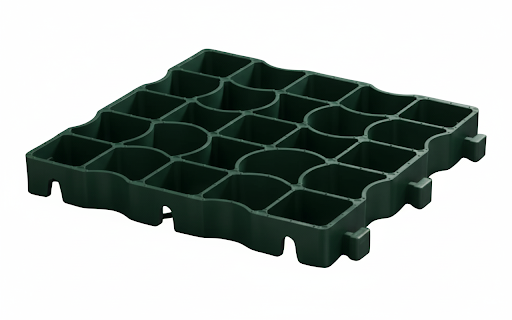 Durable green plastic grass pavers stabilizing a caravan site pitch, preventing rutting and providing a firm base for the awning and vehicles.