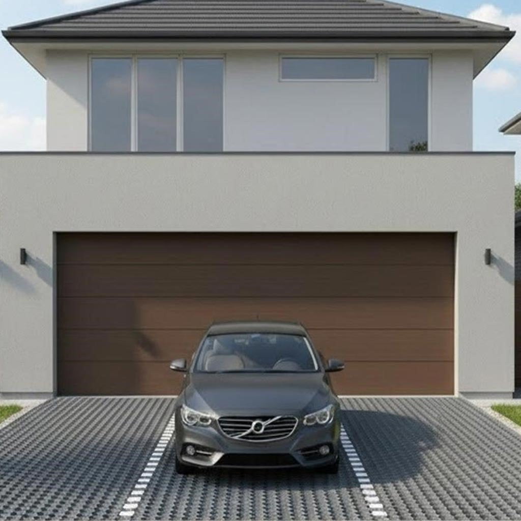 Modern residential driveway using heavy-duty recycled plastic paving grids filled with grey gravel, featuring white painted lines to clearly define the parking space.