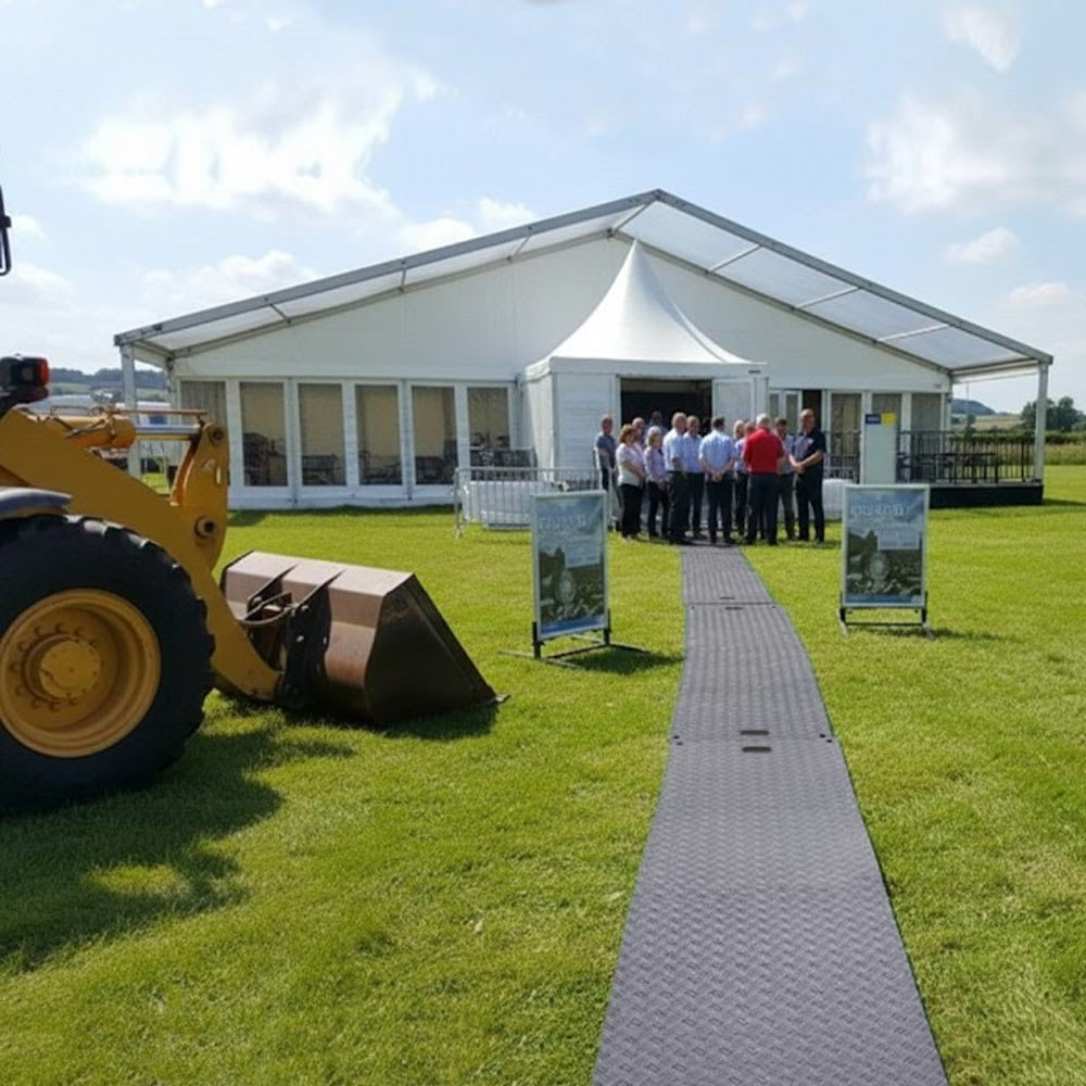 Temporary ground protection mats creating walkway to event marquee on grass field