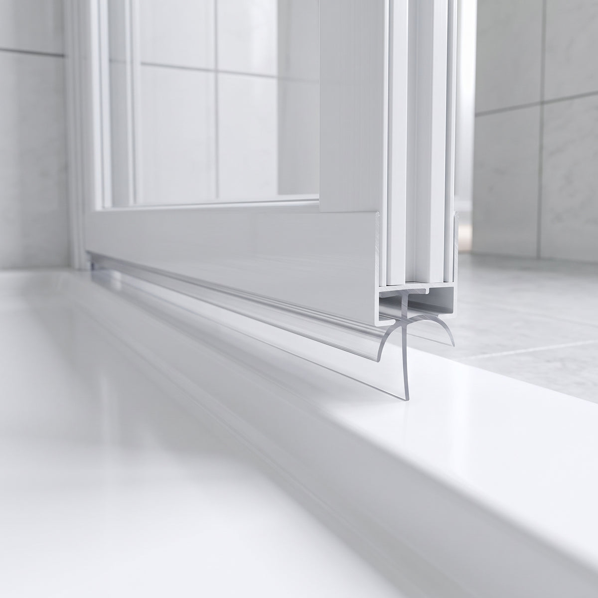 Clear seal with a curved sweeping blade under a folded white bifold door, meeting a white tray