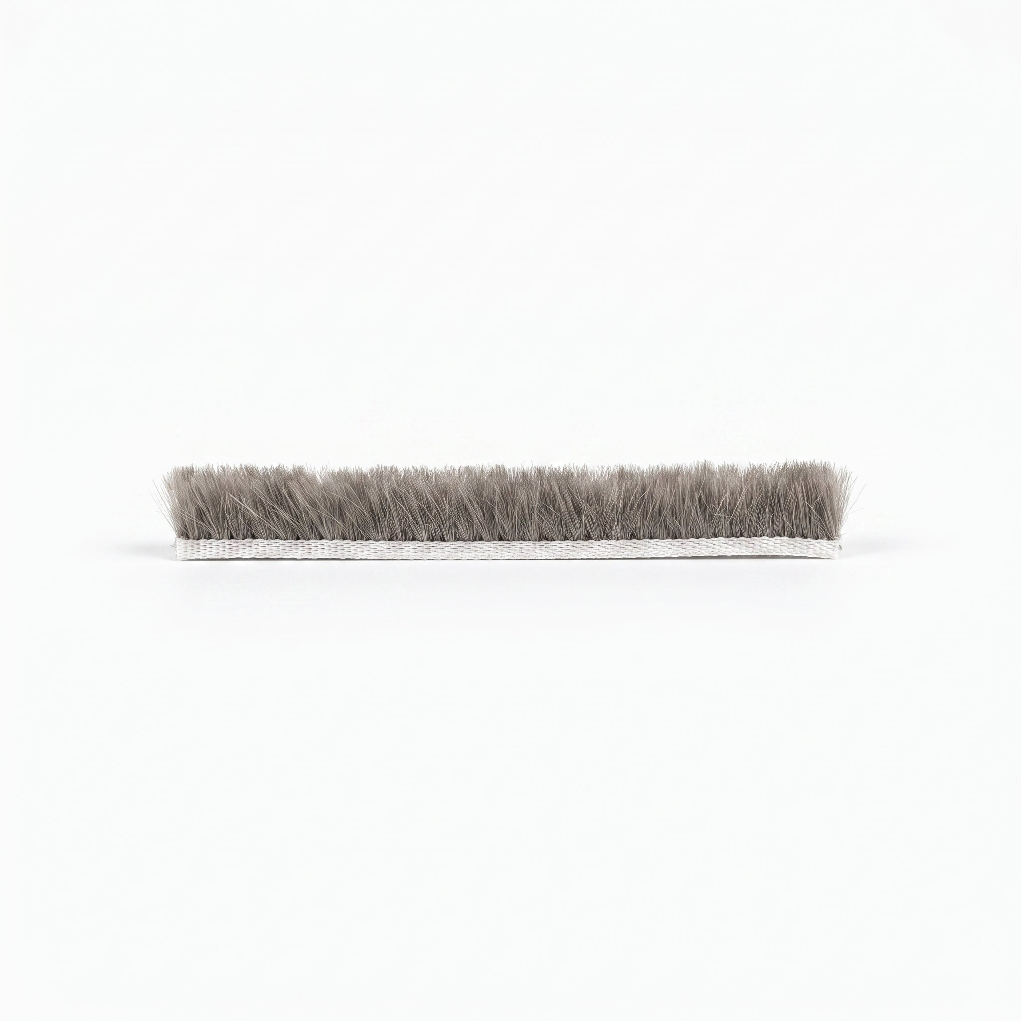 Cut length of BRUSH003 brush seal - white 5mm woven backing carrier with dense grey 10mm bristle pile