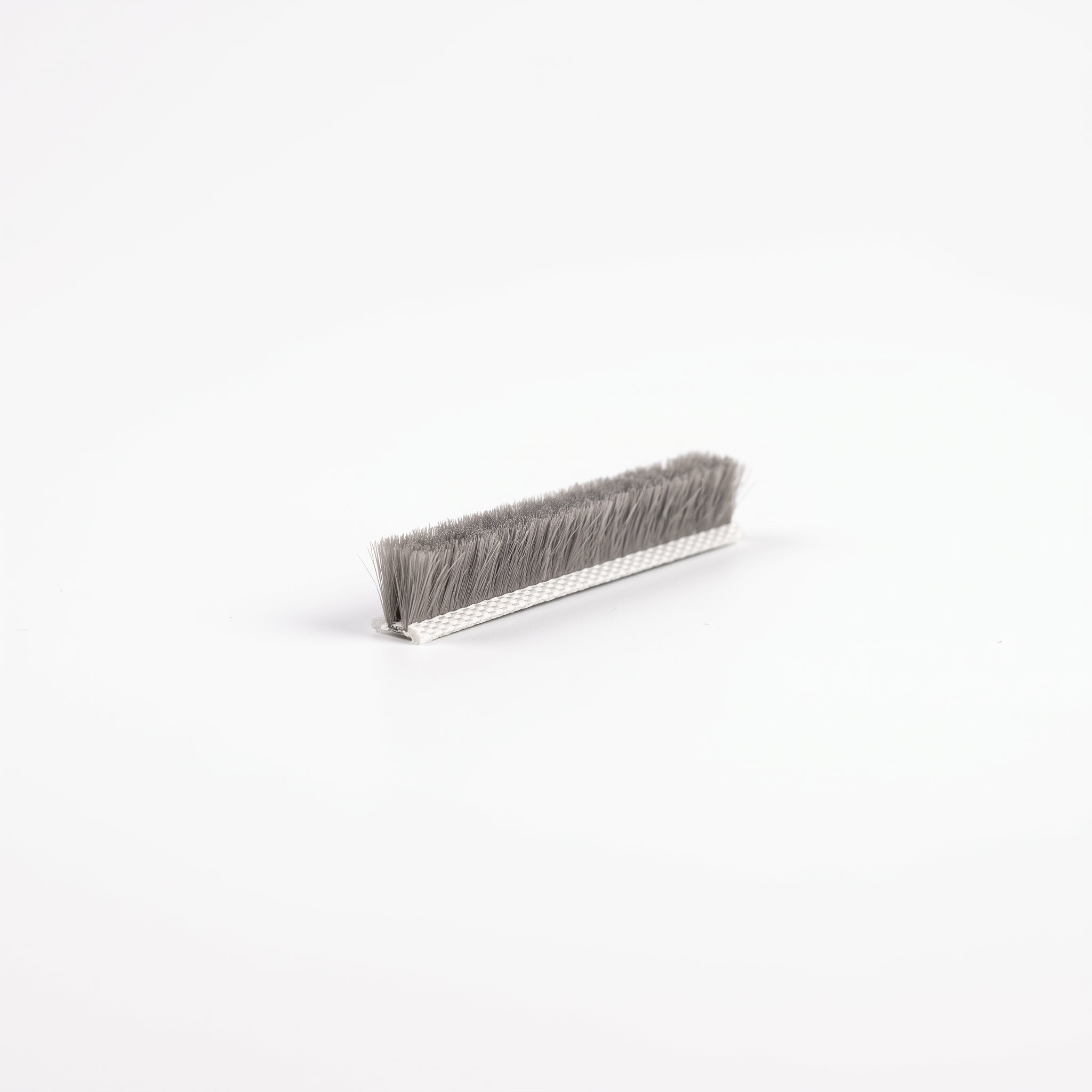 BRUSH011 brush seal - 7mm white woven T backing with dense 10mm grey bristle pile