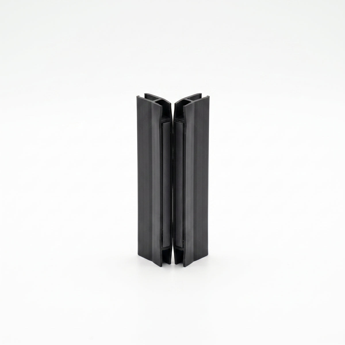 Two short black seal offcuts stood upright on white, meeting face to face down the centre join