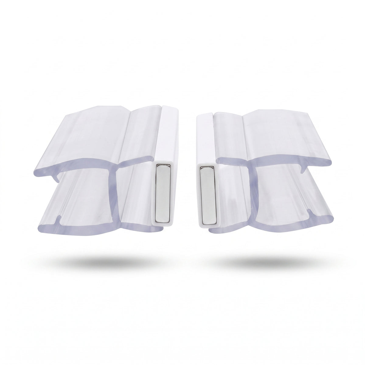 Two clear magnetic seal profiles side by side on white, white magnet blocks facing each other