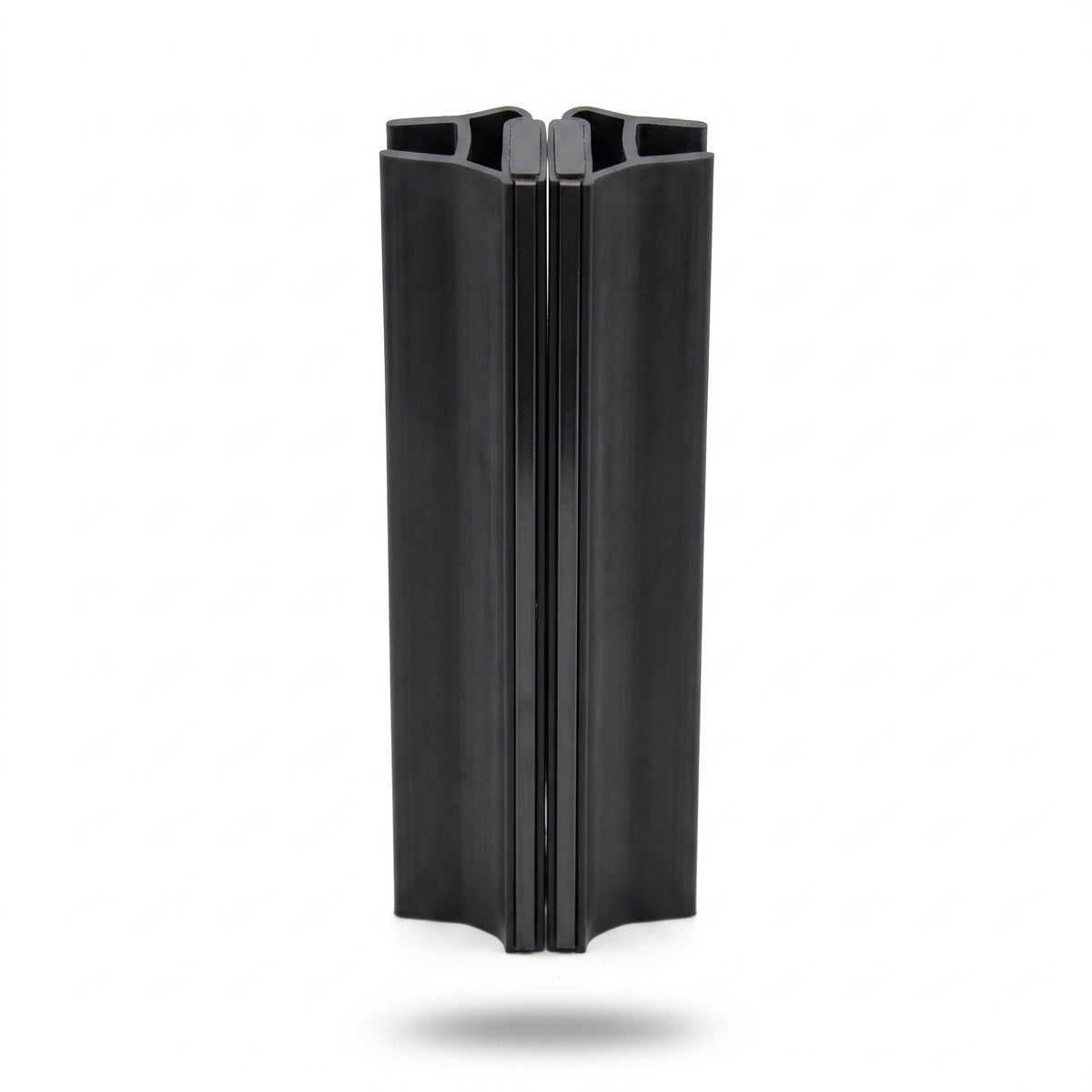 Two tall black seal offcuts standing inline on white, flared tops and feet, meeting down the centre