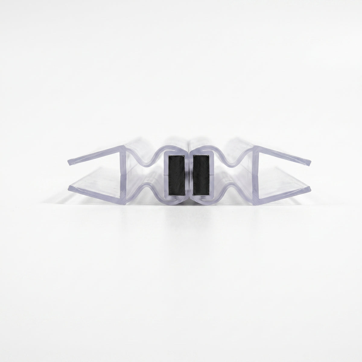 Two clear concertina magnetic seal profiles closed on white, black magnet blocks touching face to face