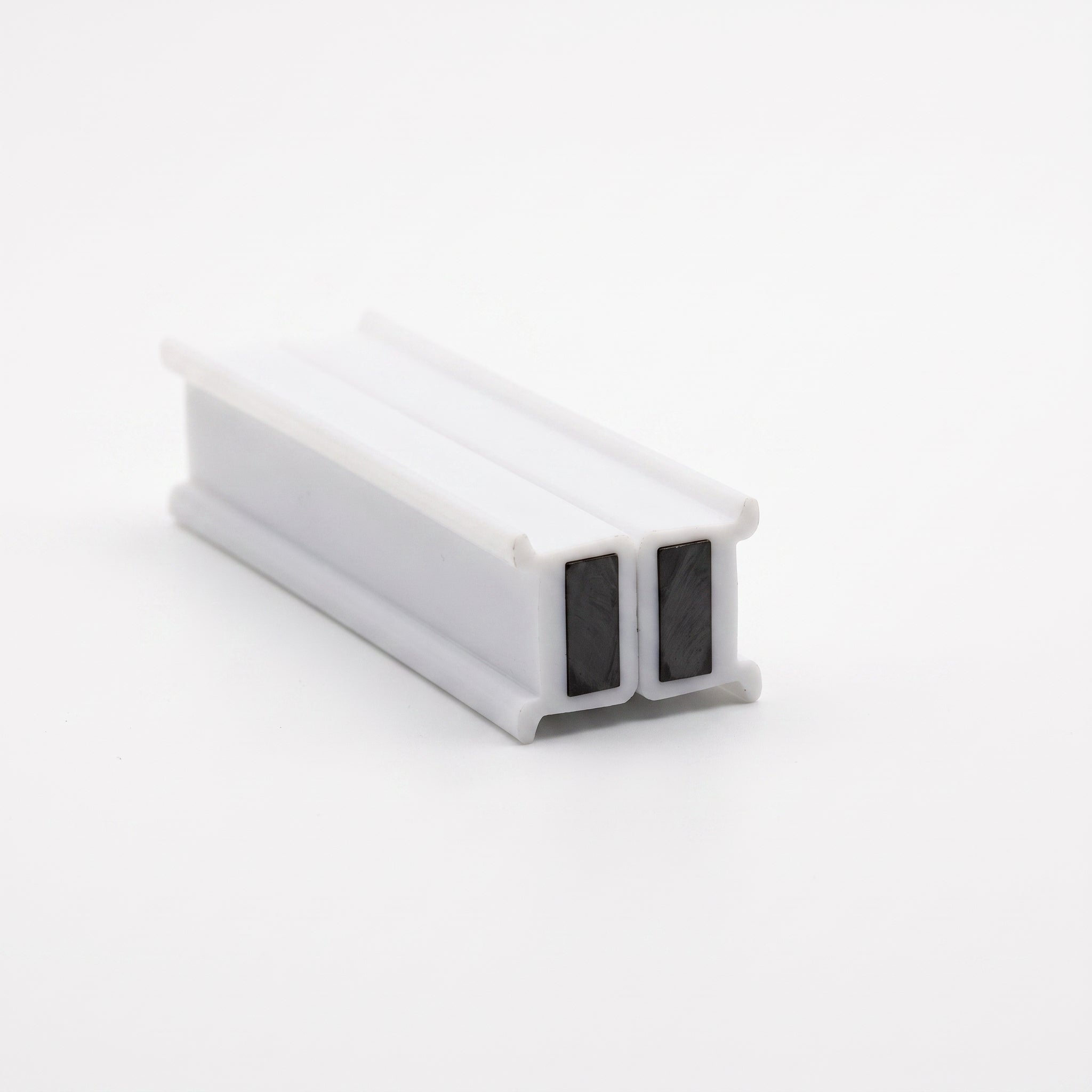 Pair of MAG031 white magnetic seals snapped magnet face to magnet face - 8mm T-bars, one magnet per piece