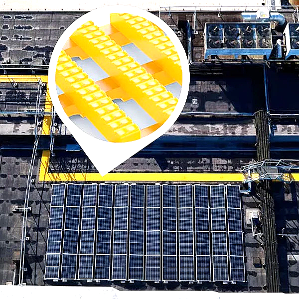 non-slip safety walkway matting installed on a commercial rooftop with solar panels. The bright yellow matting provides a clear, high-visibility safe access path around a large array of solar panels and industrial HVAC units, featuring an integrated drainage system.