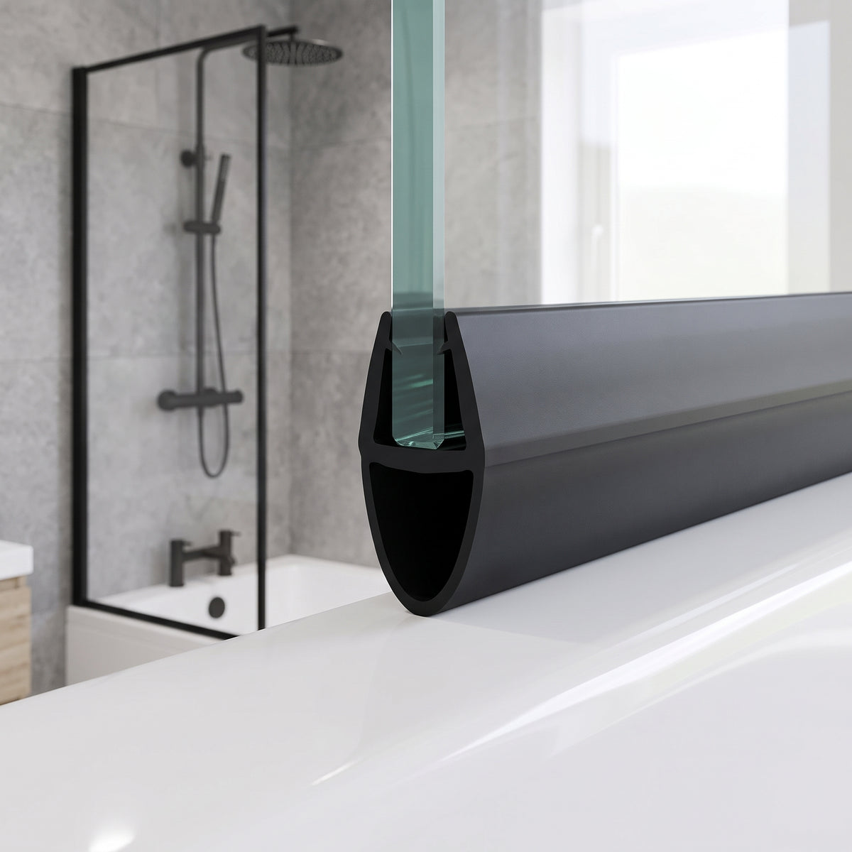 Black seal with a large hollow bulb on a glass bath screen edge, black-framed shower behind