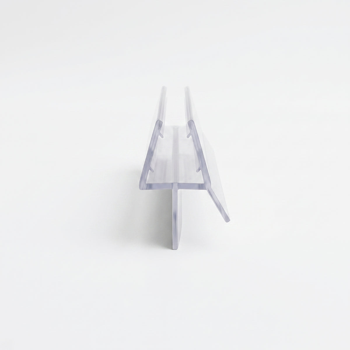 Clear shower seal end-on on white - glass channel with a straight drop fin and a wide angled deflector