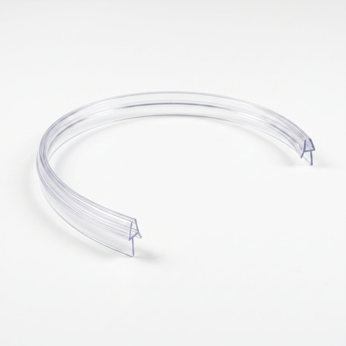 Clear pre-curved seal on white, bent into a near-circle with the blade on the outer face