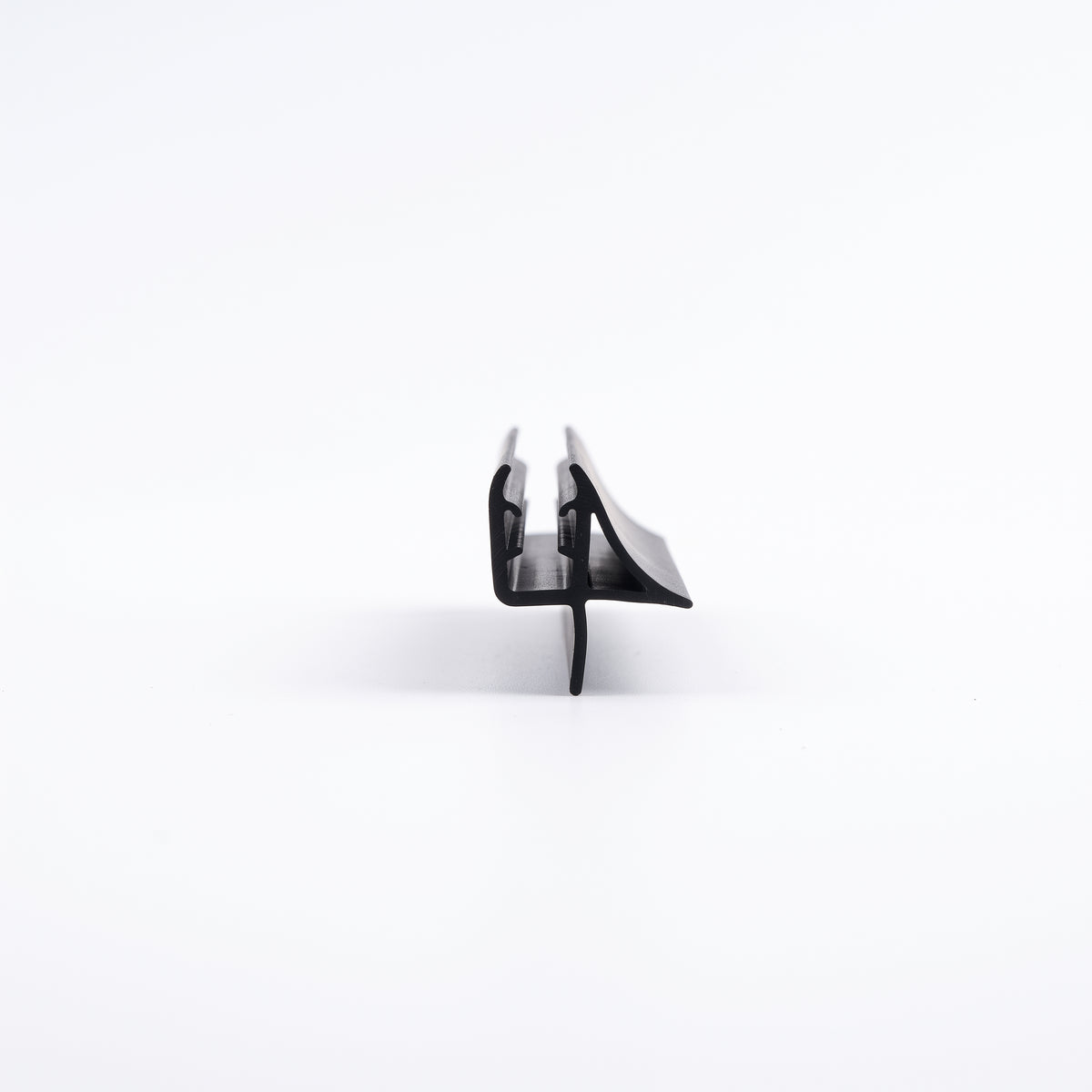 Black seal offcut end-on on white, channel with a sweeping wing above a straight drop fin