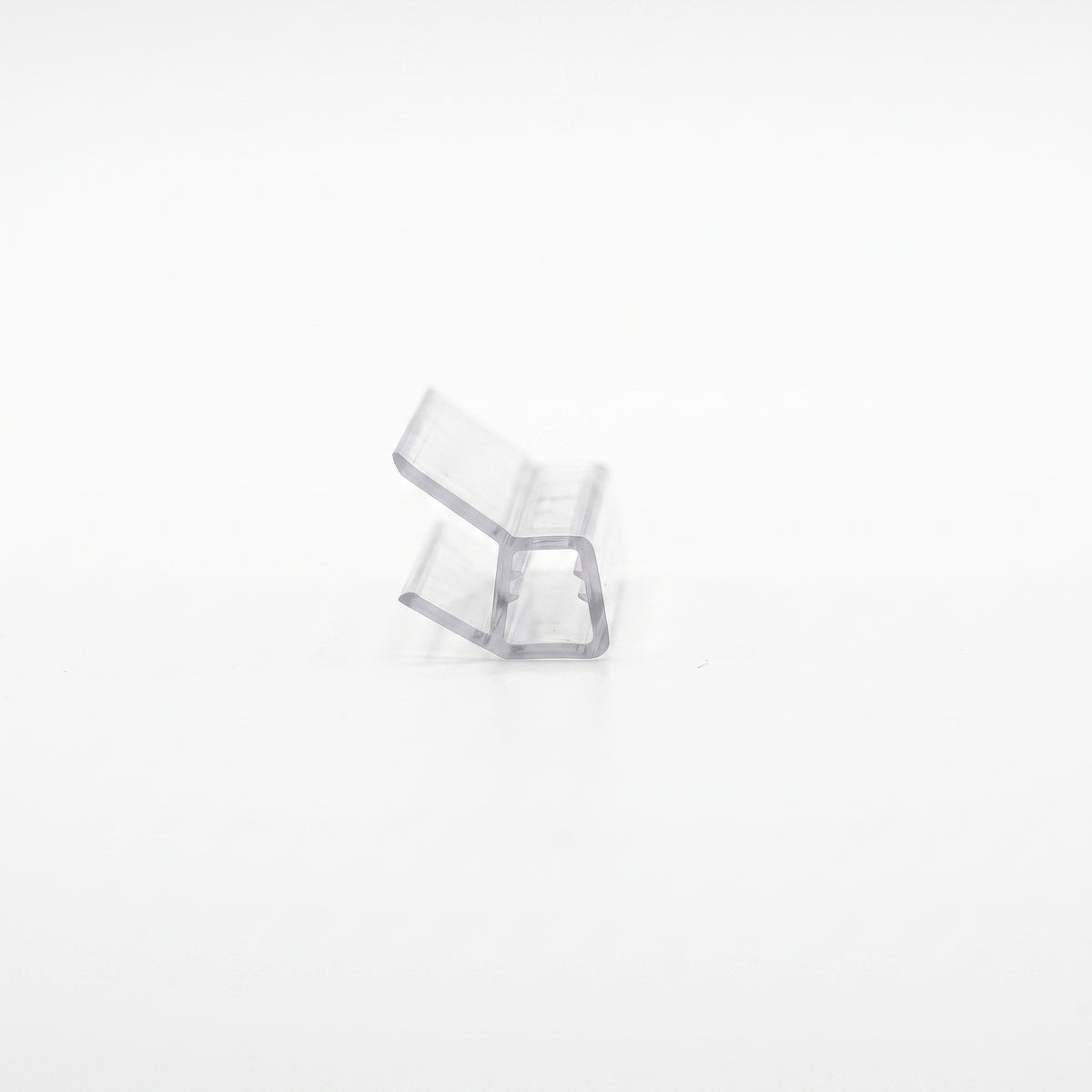 Small clear seal offcut on white, end-on - glass channel with two angled blades below