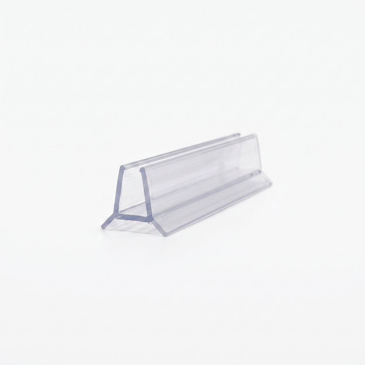 Cut length of clear shower seal on white, angled - glass channel on two splayed triangular legs